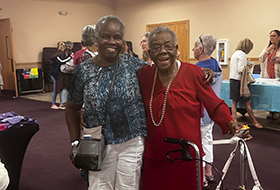 Two ladies from ministry smiling at camera.